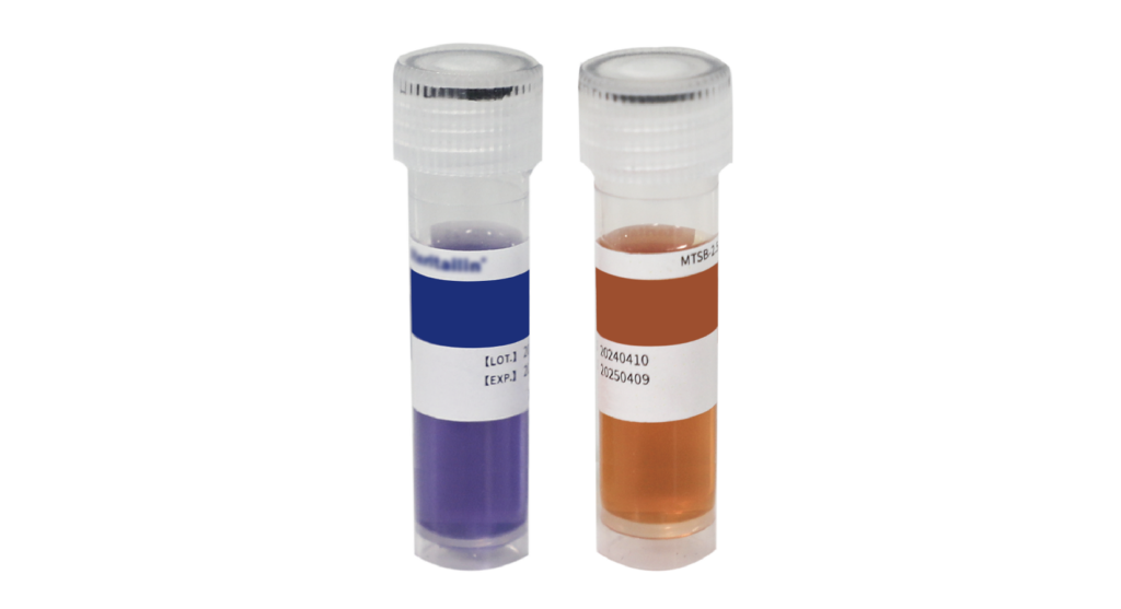 Two clear sample vials with white caps, one containing dark blue liquid and the other orange, labeled for lab analysis and standing upright side by side