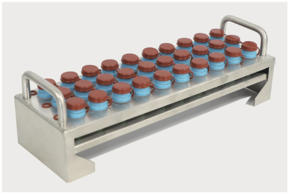 Metal lab rack holding many small vials with red caps and blue labels arranged in rows