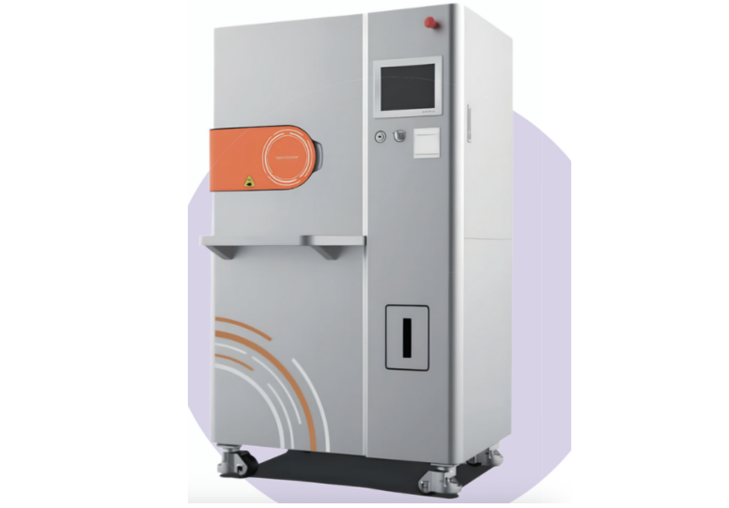 Industrial processing machine with an orange front hatch and control panel on the right, mounted on caster feet.