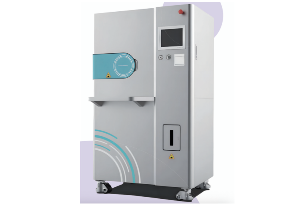 Large gray industrial machine on wheels with a teal loading door and control panel, against a pale purple background.